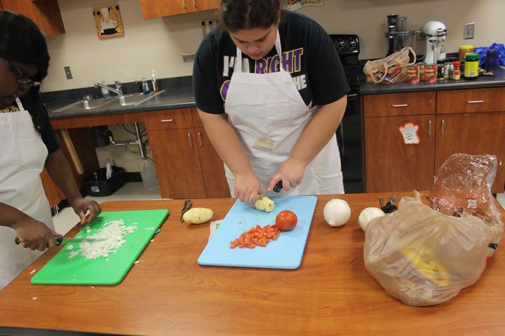 Sophomore+Samantha+Rios+chops+veggies+for+burritos+in+cooking+class.+Substitute+teacher+Maggie+Reeder+has+the+kids+cooking+on+a+regular+basis.
