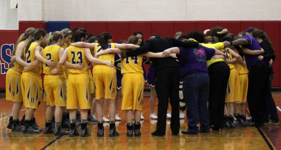 The Lady Bison huddle up with coaches, drill team members and cheerleaders after their victory last night against Anderson-Shiro. The 58-40 victory gives the girls a Bi-District title and has them challenging Jarrell for Area on Friday.