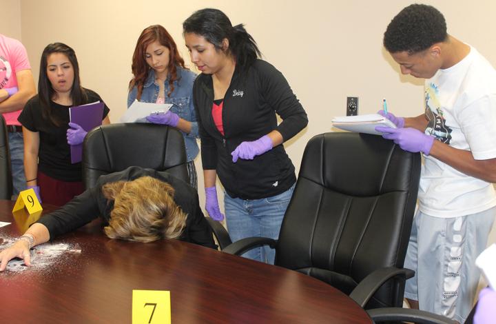Senior Deisy Zaldivar collects a hair sample from the lifeless body of assistant principal Janet Slaughter.