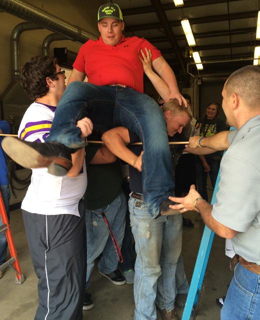 FFA students Christopher Yates and Shane Nelson lift senior Ben Reeder up and over the goal while adviser Henry Goff makes sure everyone stays safe. The group also had a team-building day at the beginning of the school year called Battle of the Gavel.