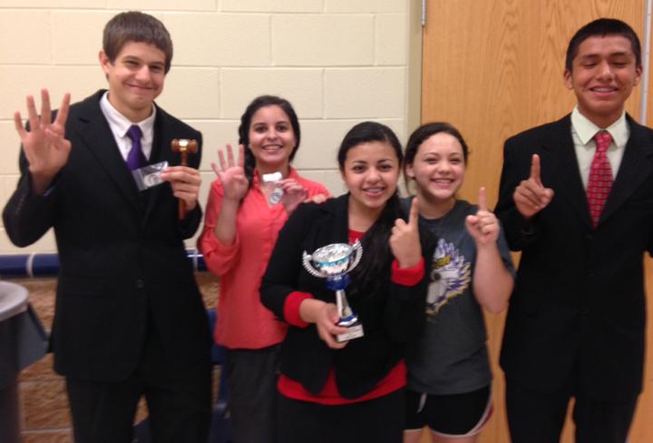 Debaters Evan Grisham, Kendall Morales, Nadia Garcia, Lilah Molina and Jordy Maltos pose with their round wins and hardware after a speech meet in Leon. The speech team will compete at two more meets in December.