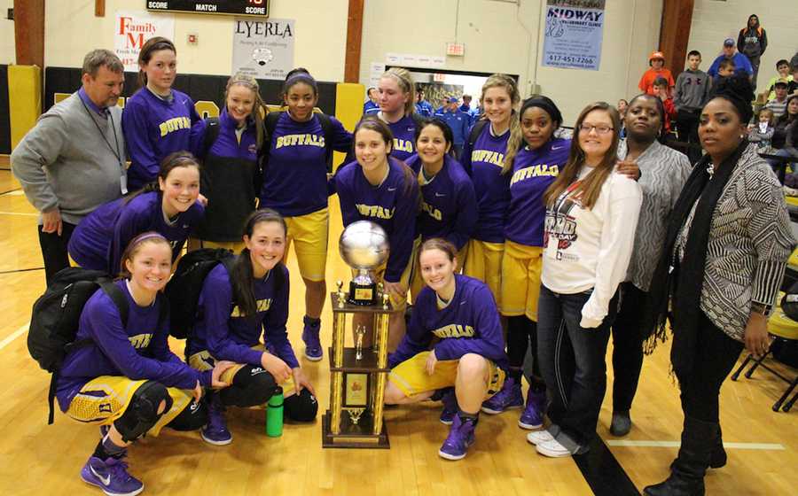 The varsity Lady Bison pose with their second-place trophy at the end of the tournament.