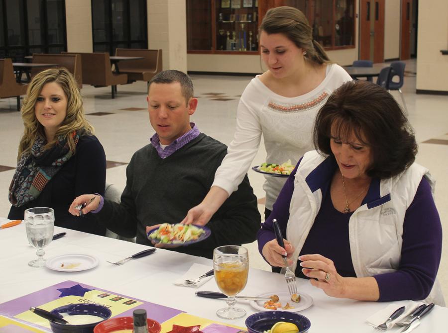 Freshman Chelsea Harter serves salads to board members Pat Bell and Randy Ayers and Ayerss wife at the school board appreciation dinner last week.