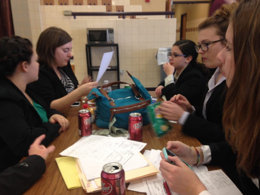 Debate members have a working lunch between rounds at a meet at Godley High School. The students and their coaches had to leave at 5:15 am to make it to the meet. 