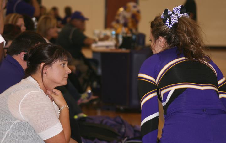 Senior Kayla Hutchins checks in with cheer sponsor Cheryl Lack during Meet the Bison in August.