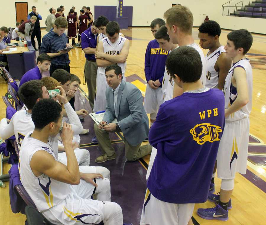 Coach Welch talks with his team between quarters.