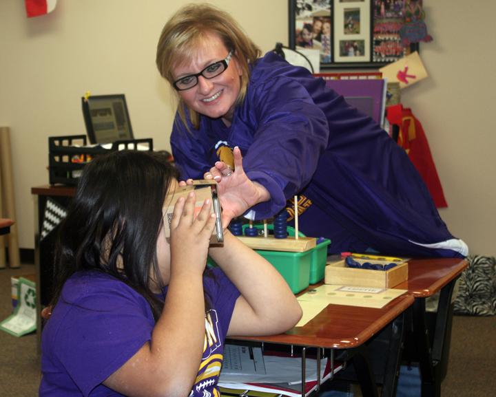 Teacher Katie Villarreal helps freshman Lizette Vazquez with the new viewer during class.