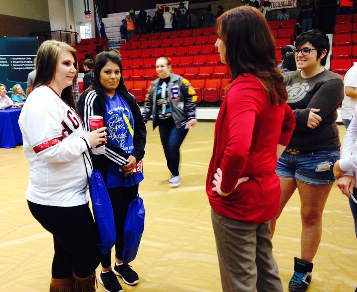 Seniors Makayla Troyer and Brittnie Garcia discuss career options with a vendor at the Navarro College Career Fair.