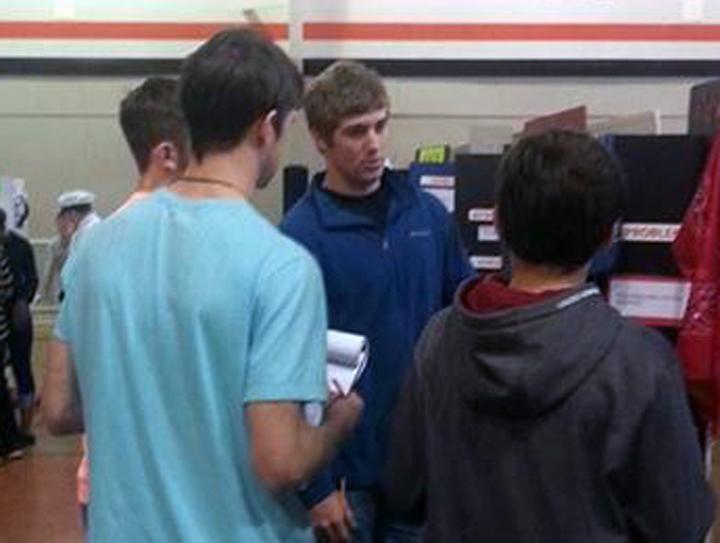 Logan+Freeman%2C+Cameron+Varner+and+Dylan+Harris+interview+a+student+during+the+Leon+County+Science+Fair.