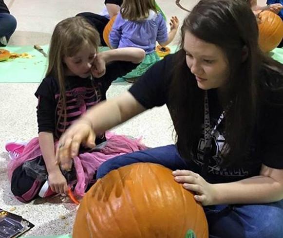 Senior+Brianna+Johnston+works+on+her+pumpkin+with+her+preschool+helper.