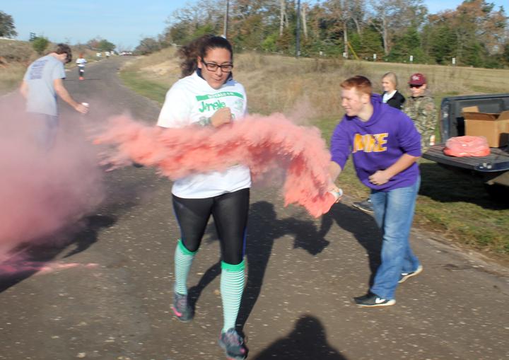 Senior+Miryam+Zapata+takes+a+hit+of+color+from+4-H+member+Matt+Gilliam+during+the+color+run.