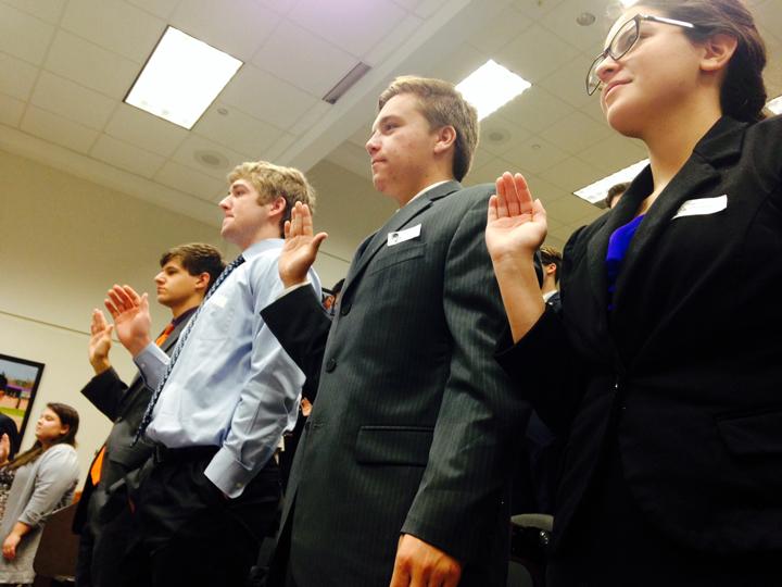 Congressional debate students Kendall Morales, Noah Rubel, Logan Freeman and Evan Grisham are sworn in before district sessions. This was the first year for BHS students to compete in this event.