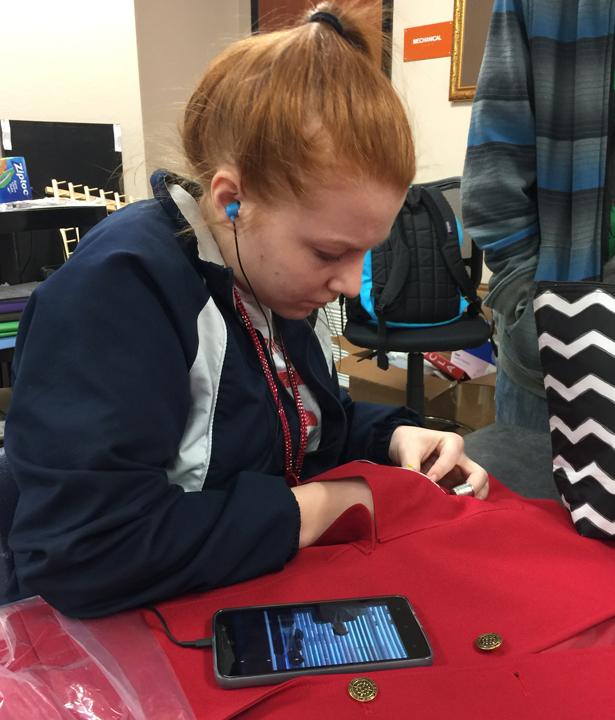 FCCLA member Jessica Devore sews her patch onto her jacket to get ready for the FCCLA Regional Convention.