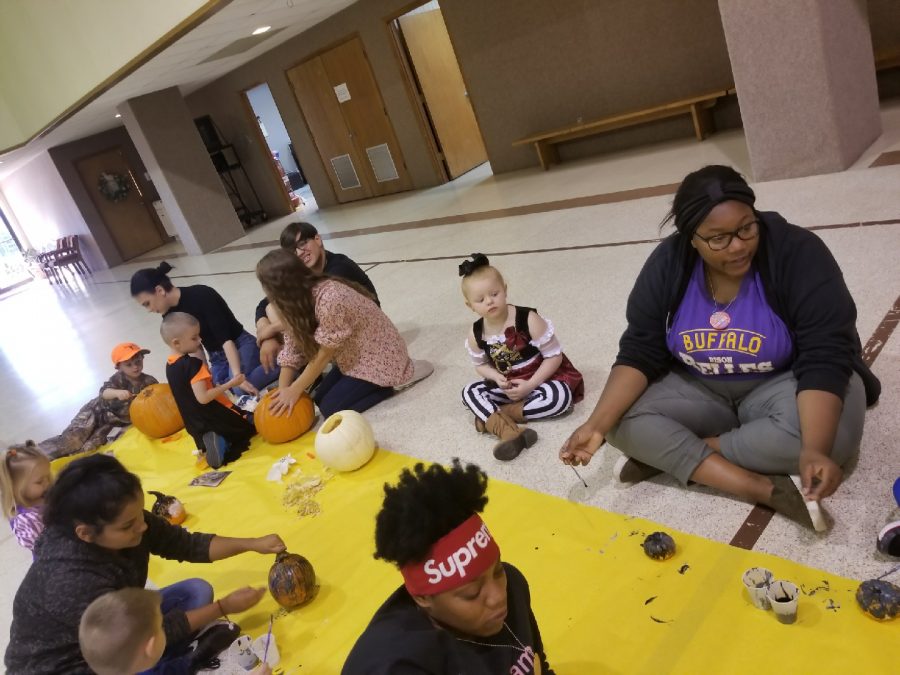 FCA students carve pumpkins with preschoolers