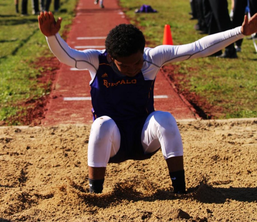 Freshman Aiden Savage sticks his landing while competing in the triple jump. Several students advanced to area in field events. The area meet will be next week in Crockett. 
