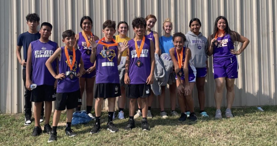The Bison cross country runners show off the medals they earned at the Teague meet.