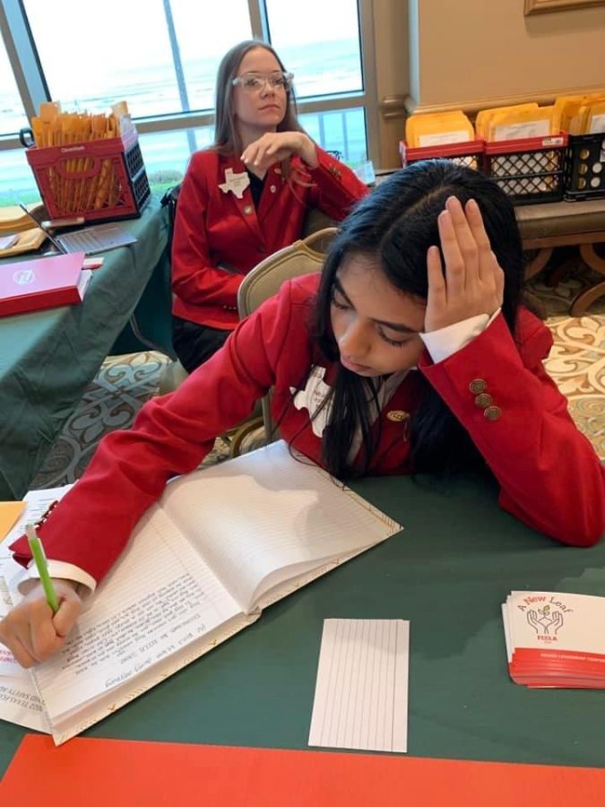 Junior Pari Jariwala works at the registration desk at the FCCLA Regional Convention. Jariwala was elected to regional president for next school year.