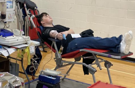 Junior Jeffrey Johnston keeps his thoughts to himself while he donates blood.