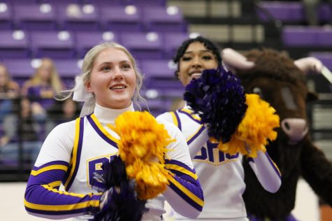 Senior cheerleaders Avery Best and Alani Jones cheer during Meet the Bison, which brought in $31,500 for the athletic teams, band, Belles and cheer.