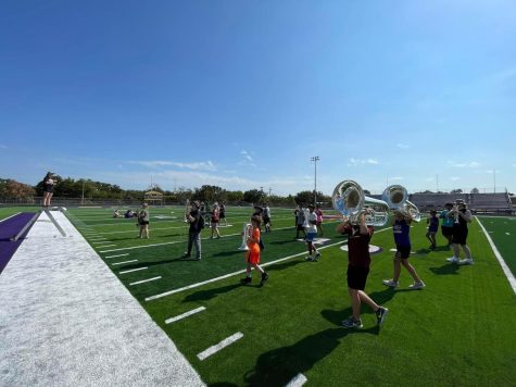 The band hits the new turf on the football field for an on-field practice. The group will perform at halftime Friday night in Centerville.