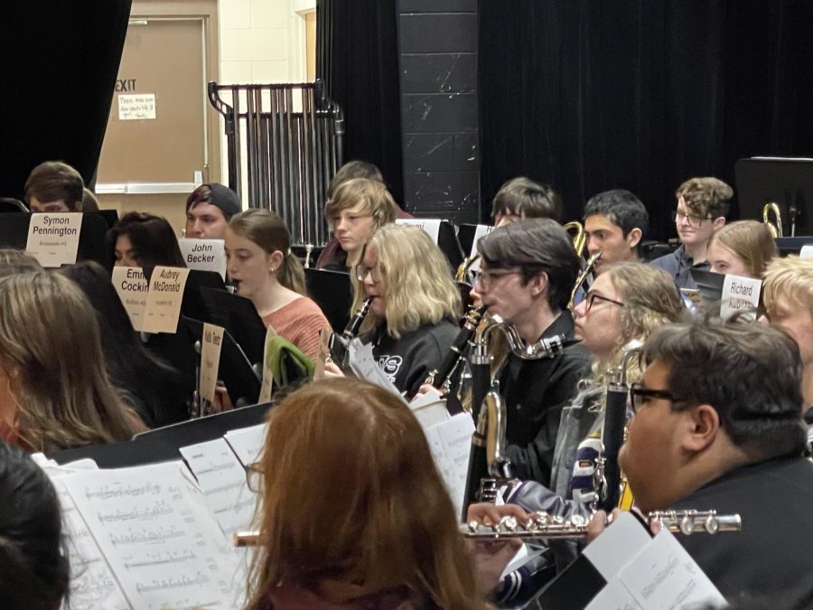 Junior Emma Cocking is surrounded by the other members of the CenTex Honor Band as they rehearse for their concert.