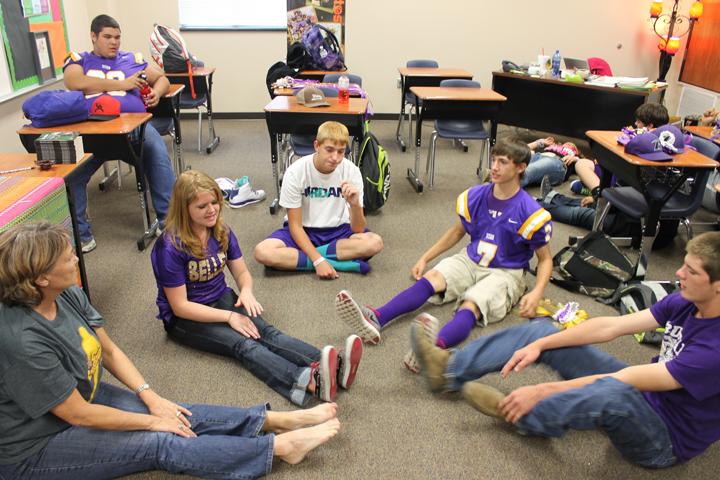 Spanish teacher Cindy Eppes stretches with her students during class to break up the class period. Eppes and many of her students are starting the Spanish Club back up this year. 