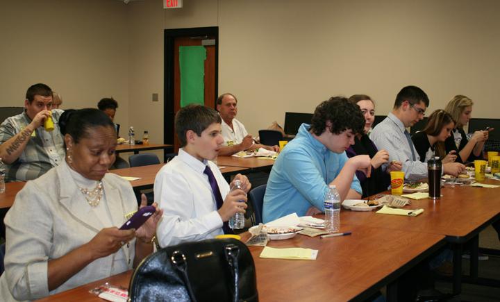Students from the speech class and the adult members of the mock trial take a quick break for lunch before continuing to work on the evidence and debates surrounding the mock trial that an Arkansas lawyer argued in front of them Tuesday. The trial he was practicing on is a civil matter that will be tried in Leon County later this year.