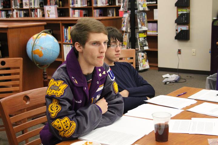 Seniors Preston Mosley and Ryan Slatter listen to the debate teacher who came to work with the group and their coaches. CX debate competes at district on Jan. 30.