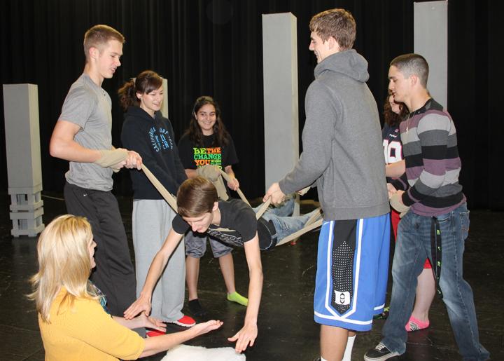 Director Jill Henson and cast members work on practicing their new Commedia techniques, which they plan to use in the OAP this year. Senior Preston Mosley is practicing his falls. 