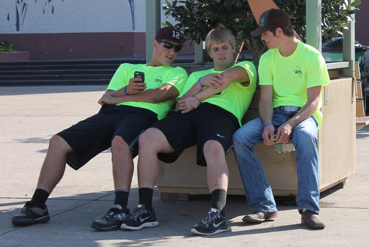 Clay McGill, Jordan Bryson and Lane Solley take a break while spending the day at the state fair. The FFA and FCCLA members delivered canned goods for the food drive and took part in other fair activities for the groups.