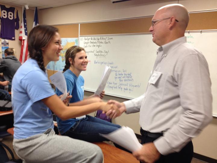 Superintendent Lacy Freeman shakes hands with junior Allison Grissett during the history class simulation. Freeman joined the class for the first day of the activity.