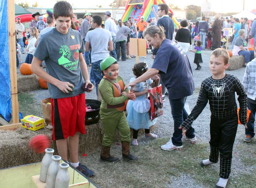 Sophomore Evan Grisham works a game booth at Pumpkin Patch at First Baptist Church. 