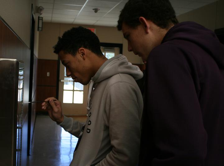 Seniors OT Garcia and Roy Kuykendall check the hallway for fingerprints while they search for Sully, the science department lizard. 