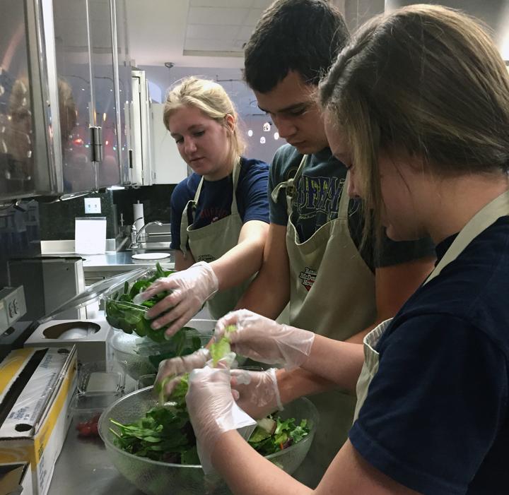Natalie+Freeman%2C+James+Rodell+and+Kynlee+Driskill+work+on+salads+at+the+Ronald+McDonald+House+kitchen.+The+students+helped+prepare+and+serve+lunch+for+the+residents.+