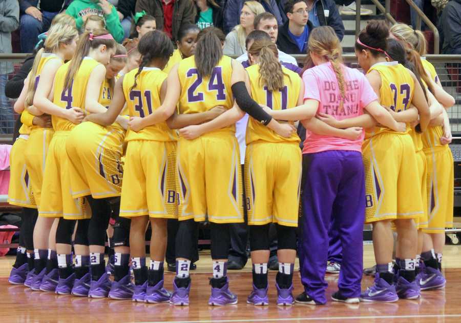 The Lady Bison huddle with coach Jo Jenkins before their Bi-District game. 