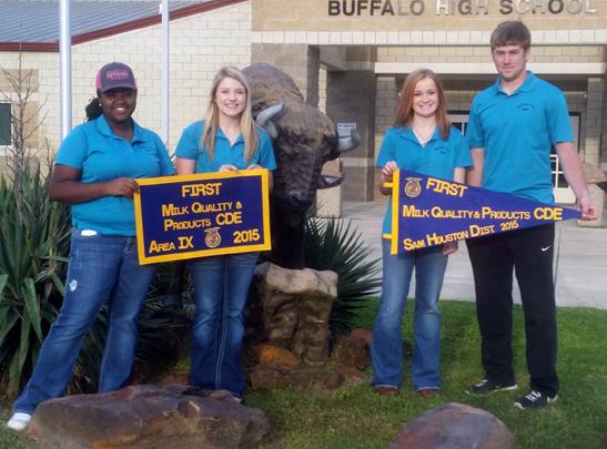 Adrian Randle, Jacie Jones, Taylor Shelton and Logan Freeman show off the banners they won in the milk judging competition. Their team and the Meats Team is advancing to state competition.