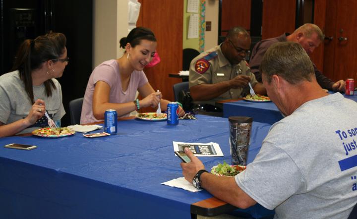 Teachers and law enforcement officers enjoy a luncheon together on the last day of the event. FCS teacher Wendy Neyland's students and many of the faculty created the luncheon.