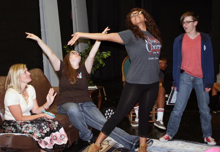 Theatre director Jill Henson works on movement and expression with some of her cast.
