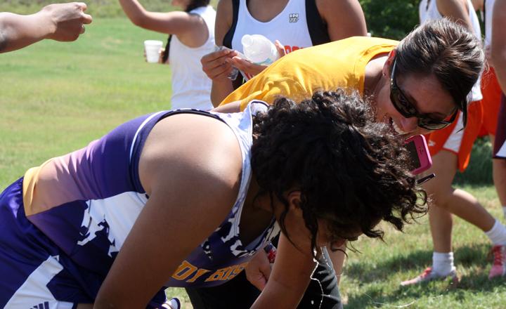 Freshman Jasmine Kolb catches her breathe after her 11th-place run on the JV team.