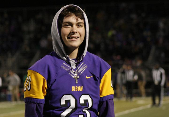 Freshman Dirk Kilgore hangs out on the sidelines at the Bison playoff game in November. Kilgore was unable to play in the game after receiving a concussion the week before. 