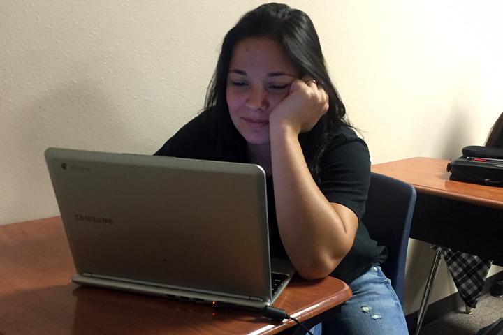 Denise Wall works on a class assignment on her Chromebook.