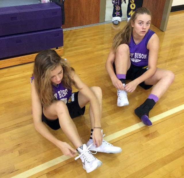 Freshmen Mollie Dittmar and Andrea Daniel lace up before hitting the court.