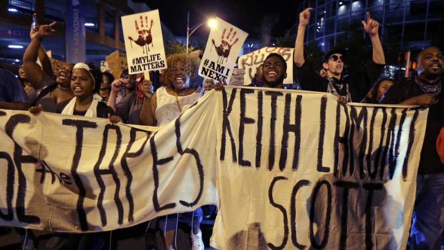 People march in Charlotte, N.C., on Sept. 23 to protest the fatal police shooting of Keith Lamont Scott. The Mecklenburg County district attorney said Wednesday he was entirely convinced that the officer who shot Scott was lawful in using deadly force.