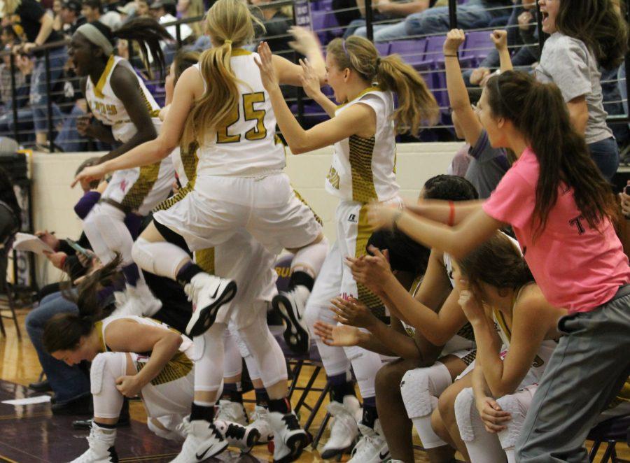 The bench goes wild after a three-pointer by senior Jordan Jenkins.