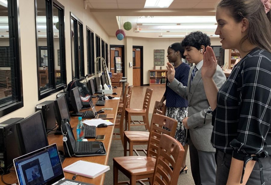 Nicollette Arabie, Omar Almeida and Jalea Brown take the COngressional Oath before competing in the debate for NSDA. Arabie and senior Kyle Hurst made finals. 