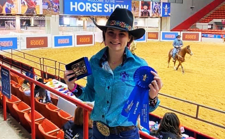 Senior+Josie+Henson+shows+off+her+winnings+from+the+Houston+Livestock+Show+and+Rodeo.+Josie+will+ride+for+the+Sam+Houston+State+University+team+next+year.