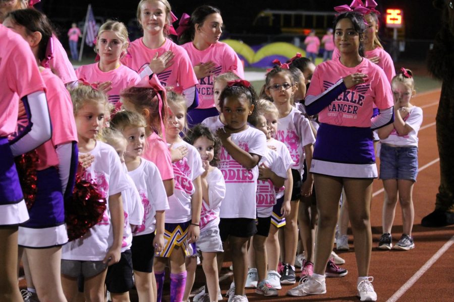 Saloni Jariwala and the other cheerleaders keep the Pre-K and Kindergarten cheer campers lined up during the National Anthem.