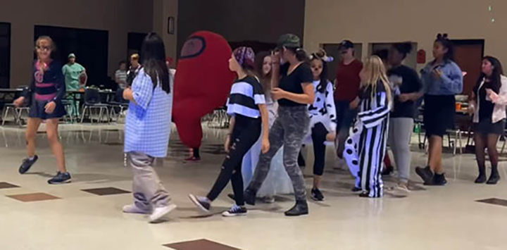 Band+students+dance+together+between+games+at+the+annual+Halloween+party.