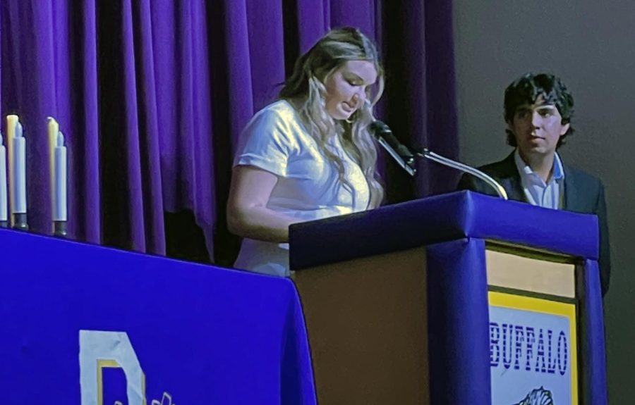 Seniors Omar Almeida and Emma Adams take part in the honor society induction ceremonies.