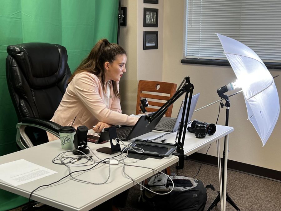 Junior Nicollette Arabie gets equipment set up for an online Congress competition last weekend. She placed fourth out of more than 70 debaters.